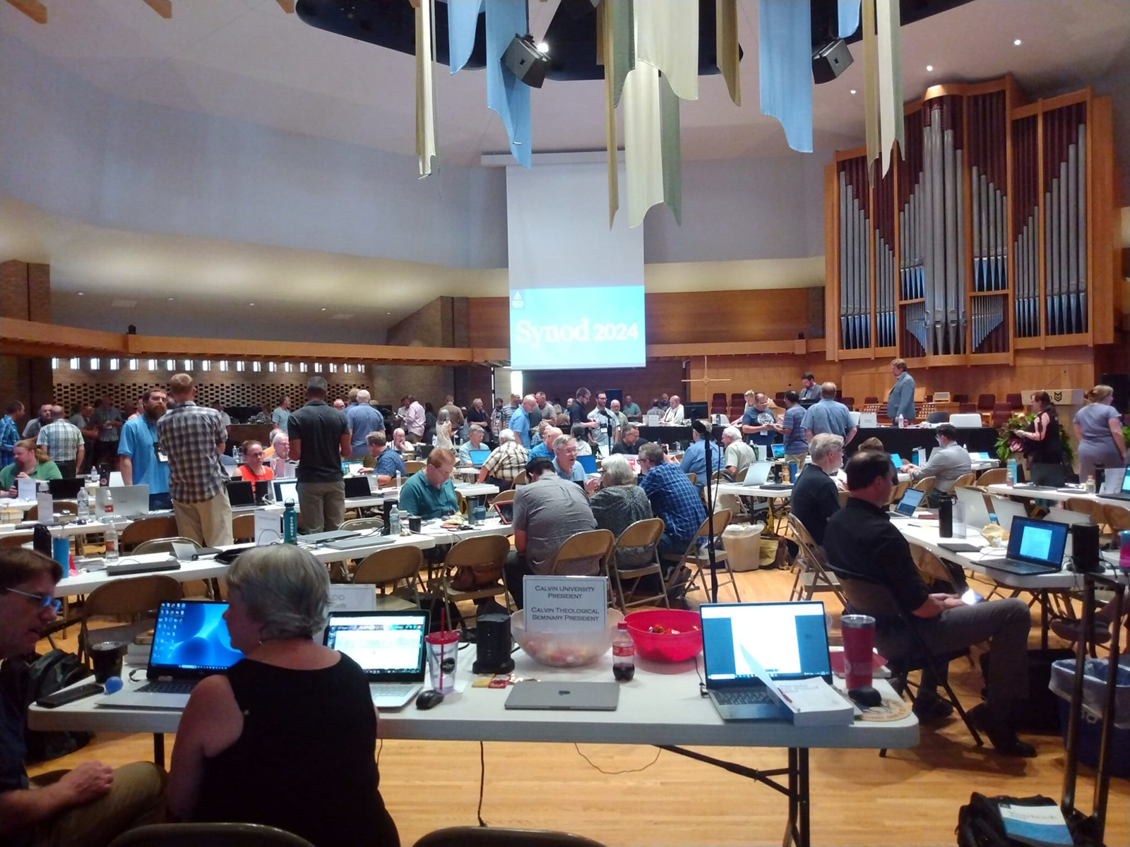 Delegates mingle during the Christian Reformed Church annual synod at Calvin University in Grand Rapids, Michigan. (Photo by Ethan Meyers)